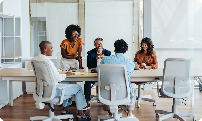 Offshore finance professionals discussing financials around meeting room table