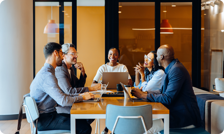 Business team discussing workforce strategy and offshoring solutions around a conference table
