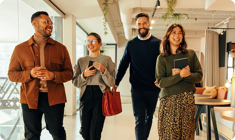 Colleagues discussing work while walking in office environment