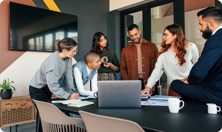Offshore sales consultants discussing sales targets around meeting table